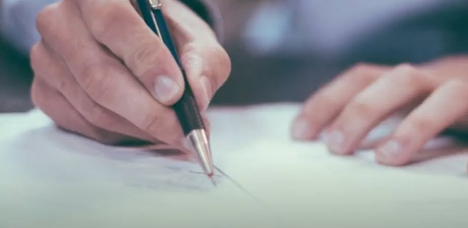 Close up of a document being signed